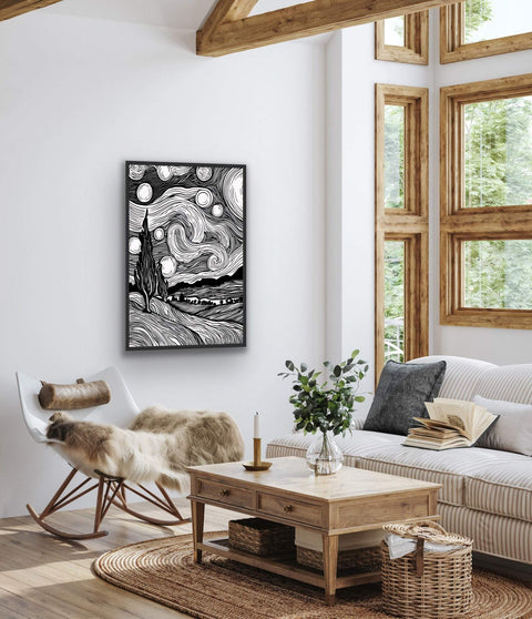 Framed poster of black and white landscape with night sky illustration, hanging in a stylish living room.