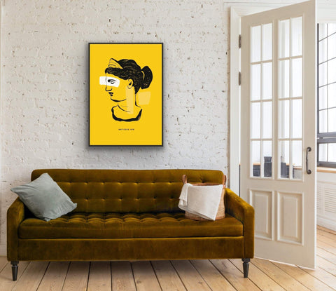 Framed poster featuring classical bust illustration on yellow background in modern living room.