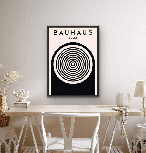 Framed poster with Bauhaus-inspired black and white geometric design, featuring 1923 typography and concentric circles, enhancing modern and minimalist decor.