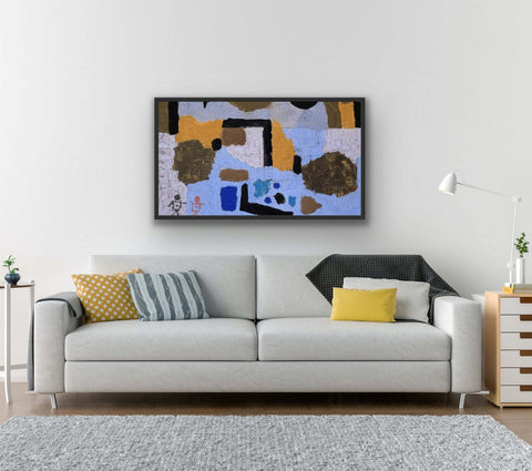 Framed abstract art print in black frame on living room wall.