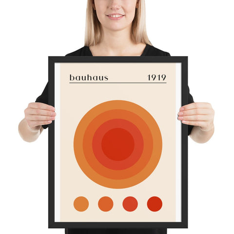 Framed photo paper poster with geometric design and vibrant colors held by person.