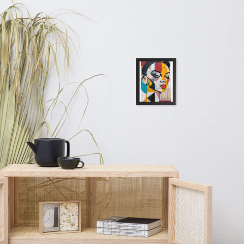 Framed photo paper poster with colorful abstract portrait on wall above wooden cabinet.