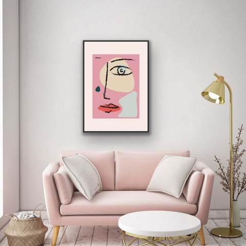Framed poster featuring abstract face design in modern home decor setting.
