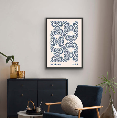 Framed poster featuring Bauhaus design with geometric shapes and minimalist colors, adding mid-century modern style.