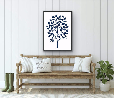 Framed poster featuring botanical tree design on a wall above a wooden bench in a cozy room setting.