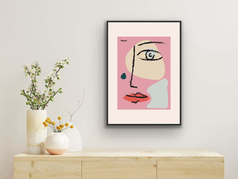 Framed poster with abstract face design, modern art for home decor.