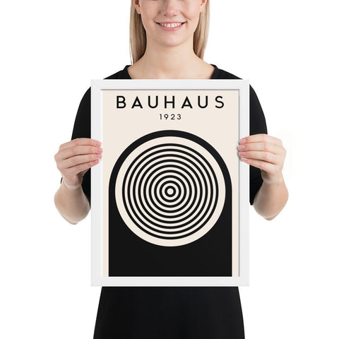 Framed poster featuring Bauhaus 1923 design with bold black and white geometric shapes and concentric circles, ideal for modern art decor.